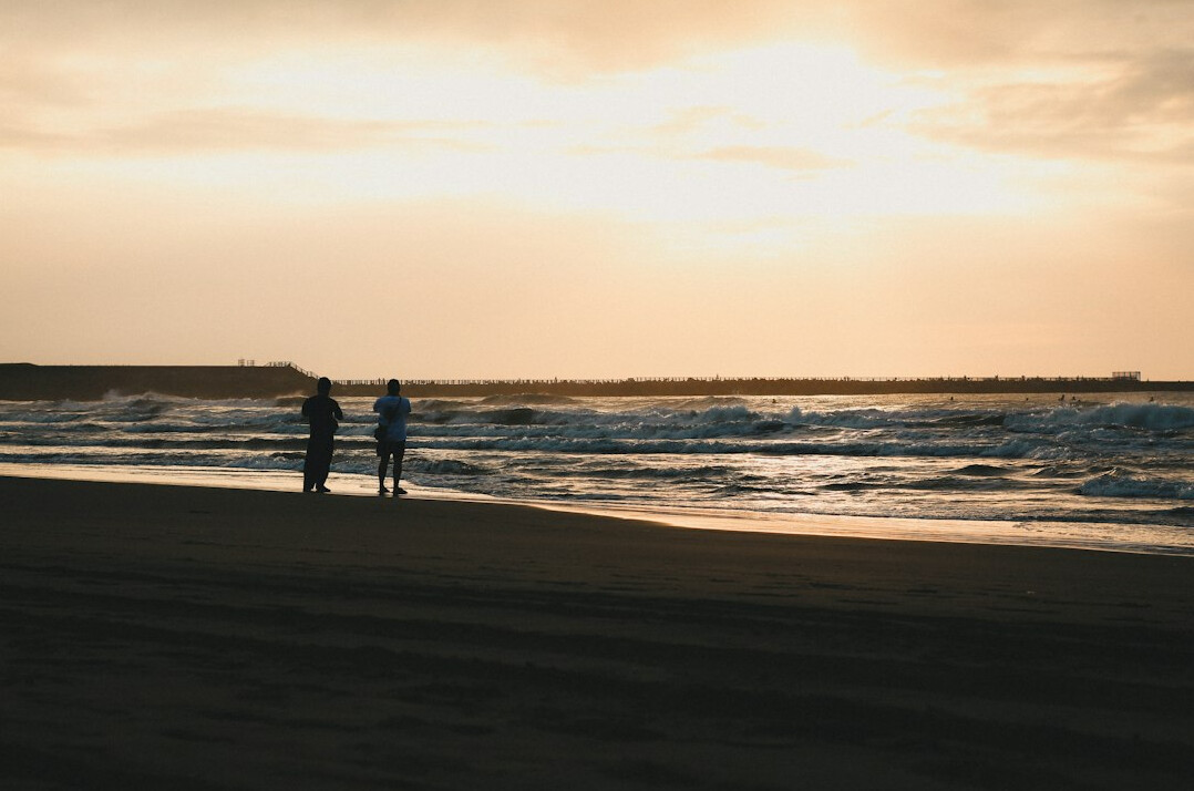 retired couple walking on beach